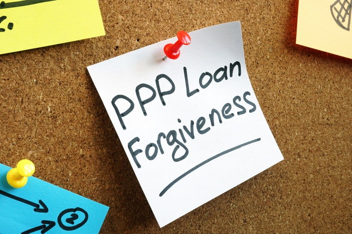 PPP loan forgiveness memo on the wooden board.