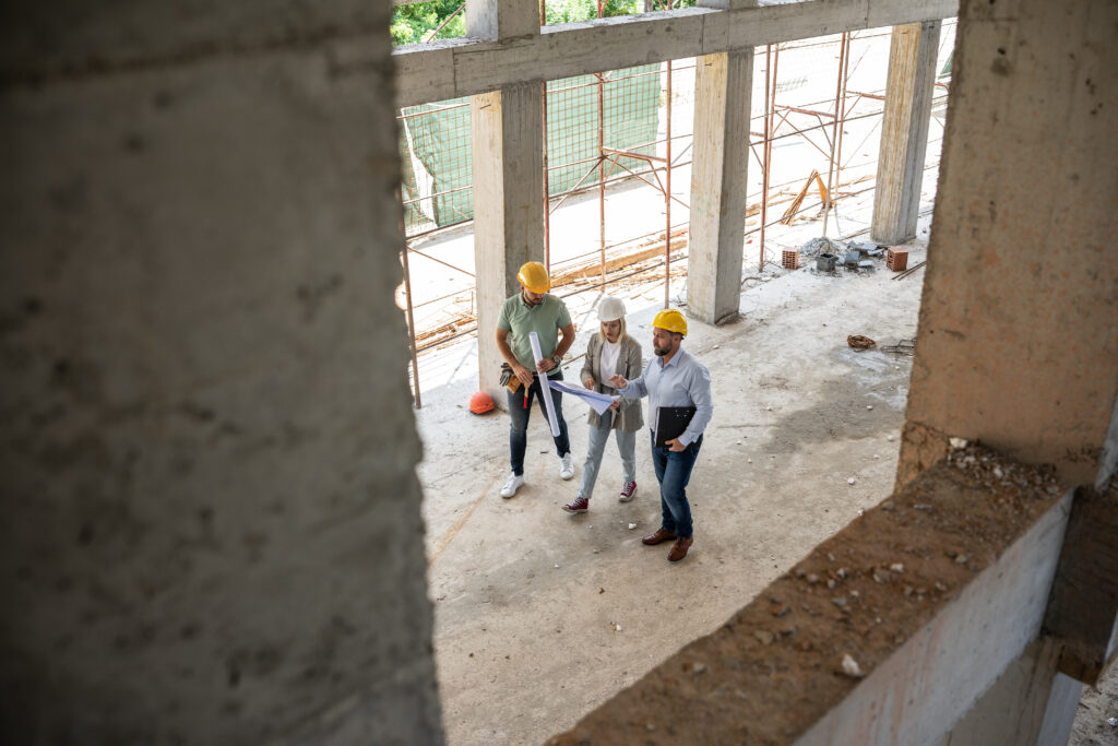 A female architect and construction managers walking a building