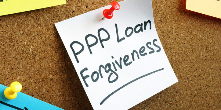 PPP loan forgiveness memo on the wooden board.